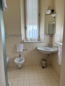 a bathroom with two sinks and a toilet and a mirror at Villa Labor in Pugliano +23 photos