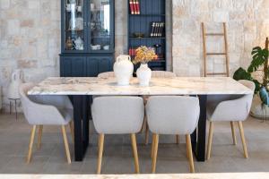 a dining room table with chairs and a white vase on it at Casa Barbiere Hvar in Jelsa