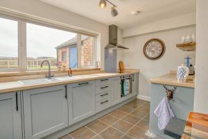 a kitchen with a sink and a window at Cosy Countryside Hideout - Pass the Keys in Whisby