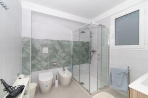 a bathroom with a shower and a toilet and a sink at Una prua sul mare in Nardò
