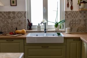 uma cozinha com um lavatório branco e uma janela em Casa Barbiere Hvar em Jelsa