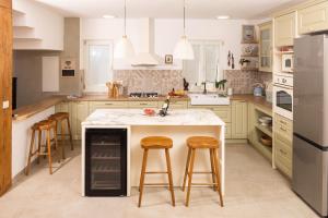 a kitchen with a large island with bar stools at Casa Barbiere Hvar in Jelsa