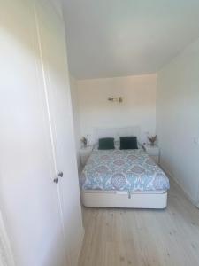 1 dormitorio con 1 cama en una habitación blanca en Cozy apartment with pool close to beach & nature, en L'Estartit