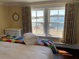 a bedroom with a bed with a view of the ocean at Saffron House in Twillingate