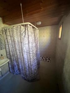 a shower curtain in a bathroom with a sink at Villa Aronia in Porvoo