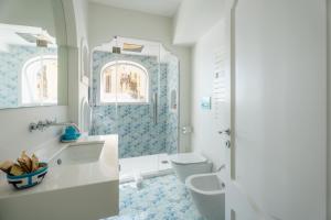 a bathroom with a toilet and a sink and a shower at Proprietà Antonio 3 unità indipendenti in Positano +46 photos