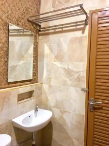 a bathroom with a sink and a mirror at Villa ChavaMinerva Bambu - Lembang in Cikareumbi 2 +22 photos