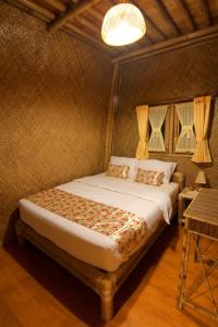 a bedroom with a bed in a room at Villa ChavaMinerva Bambu - Lembang in Cikareumbi 2
