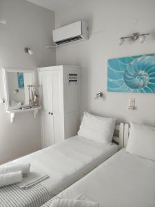 Postel nebo postele na pokoji v ubytování Vetti Rooms