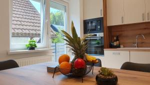 a bowl of fruit on a table in a kitchen at Apartments Seventy Seven in Kranjska Gora