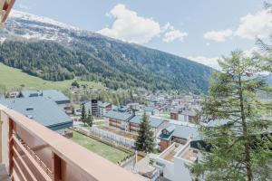 a view of a town from the balcony of a house at Appartement proche des remontées mécaniques in Leukerbad