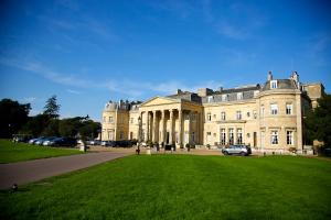 a large building with cars parked in front of it at Luton Hoo Hotel, Golf and Spa in Luton
