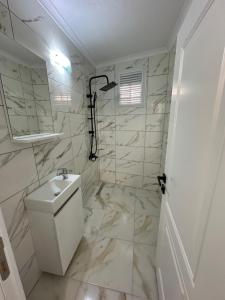 a white bathroom with a toilet and a sink at Öztürk VIP in Pelitli +29 photos