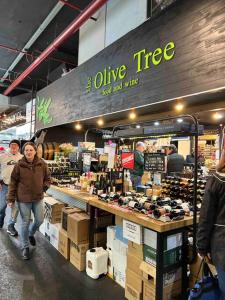 a group of people walking around a wine tree store at 259 Gouger city unit 105 in Adelaide