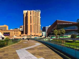a person walking down a walkway in a city at 259 Gouger city unit 105 in Adelaide