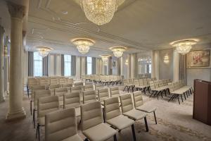 une grande chambre avec des chaises, des tables et un lustre dans l'établissement Mandarin Oriental Savoy, Zurich, à Zurich