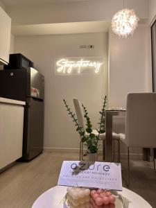 a kitchen with a table and a sign on the wall at Azure Urban Resort Residences - Staycationary Miami 1210 in Manila