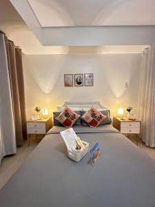 a bedroom with a large bed with two tables at Azure Urban Resort Residences - Staycationary Miami 1210 in Manila +14 photos