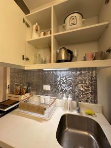 a kitchen with a sink and a counter top at Azure Urban Resort Residences - Staycationary Miami 1210 in Manila