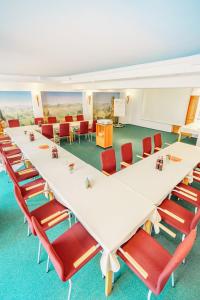 a conference room with a long table and chairs at Hotel Plankl in Altötting