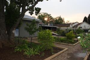 a garden in the backyard of a house at The Itumeleng Guest House in Bergville