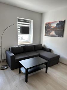 a living room with a couch and a coffee table at Ferienwohnung Flaming House 2 in Bitterfeld