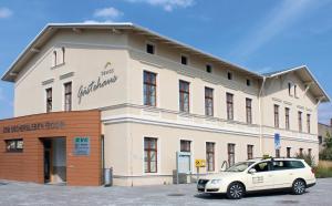 a white car parked in front of a building at BEWOS Gästehaus in Oschersleben