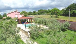 a house with a swimming pool and a gazebo at Villa Vale in Labin