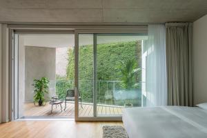 a bedroom with a large glass door leading to a patio at Wilmina Apartments & Lofts in Berlin +81 photos