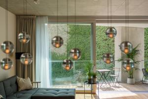 a living room with a blue couch and a large window at Wilmina Apartments & Lofts in Berlin