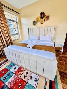 a large bed with a large headboard in a bedroom at Lookout sirwa in Naivasha +41 photos