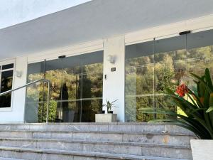 a building with large windows and stairs in front at Family Relax Apartment in Alcudia
