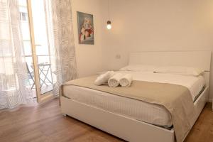 a bedroom with a bed with towels on it at Sea House - casa vacanze Savona in Savona