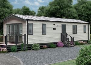 a small white shed with a porch at Aber Bay Holiday Park in Aberystwyth
