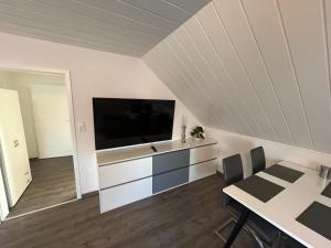 a living room with a flat screen tv on a wall at Erholung an der Nordsee in Wilhelmshaven