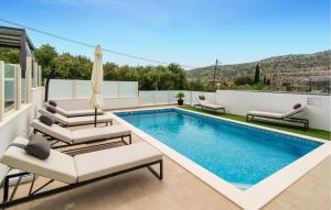 a swimming pool with lounge chairs and a swimming poolvisorvisor at Lovely Home In Srinjine in Srinjine
