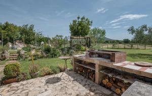 an outdoor grill with a pile of fire wood at Nice Home In Canino Vt With Sauna in Case Riminino +40 photos