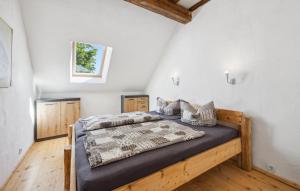 a bedroom with a bed in a room with white walls at Ferienwohnung Stefanie in Rambin