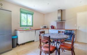 a kitchen with a table and chairs in a room at Nice Home In Plan-D'aups-Sainte-Bau in Plan dʼAups