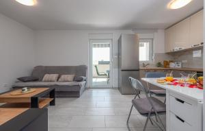 a kitchen and a living room with a couch at 3 Bedroom Lovely Apartment In Mandre in Mandre