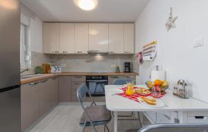 a kitchen with a table with a bowl of fruit on it at 3 Bedroom Lovely Apartment In Mandre in Mandre
