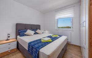 a bedroom with a large bed with a window at 3 Bedroom Lovely Apartment In Mandre in Mandre +28 photos