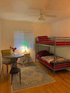 a room with two bunk beds and a table at Nice furnished Twin room #B in Stanton
