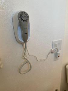 a hair dryer is attached to a wall at Nice furnished Twin room #B in Stanton