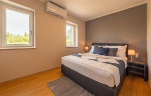 a bedroom with a large bed and a window at Lovely Apartment In Mrljane in Mrljane +35 photos