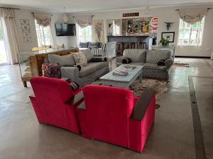 a living room with couches and a table at Lavender Trout Guest Farm in Nottingham Road