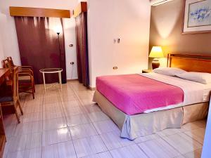 a bedroom with a large bed and a table at Masaya Hurghada in Hurghada