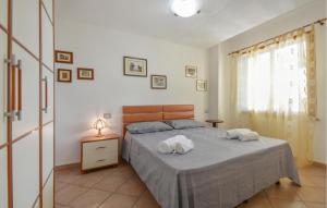 a bedroom with a bed with two towels on it at Secca in Costa Rei