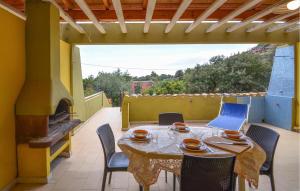 a table and chairs on a patio with a fireplace at Secca in Costa Rei