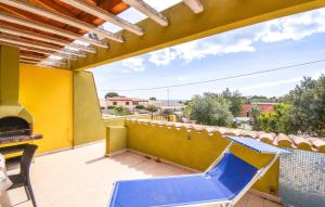 a patio with a table and a fireplace on a yellow wall at Secca in Costa Rei